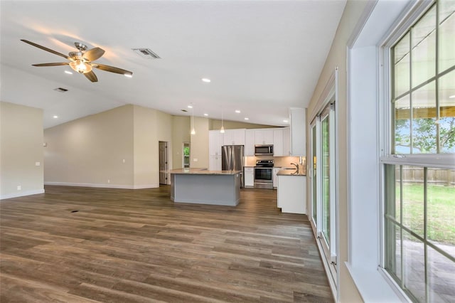 unfurnished living room with dark hardwood / wood-style floors, ceiling fan, and vaulted ceiling