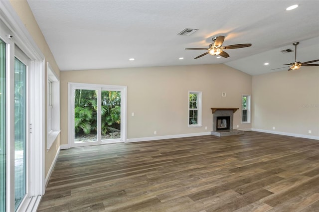 unfurnished living room with lofted ceiling, a healthy amount of sunlight, and dark hardwood / wood-style floors