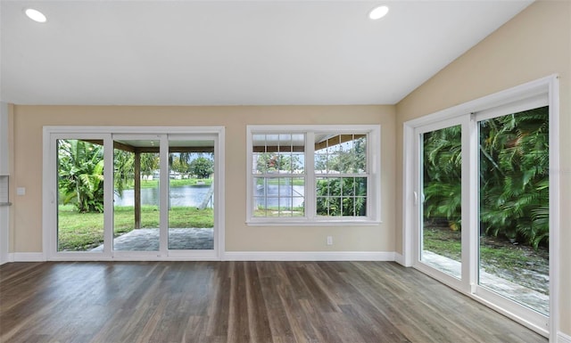 doorway featuring a water view, lofted ceiling, and dark hardwood / wood-style floors