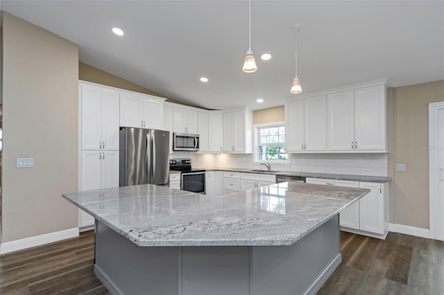 kitchen with white cabinetry, appliances with stainless steel finishes, sink, and lofted ceiling