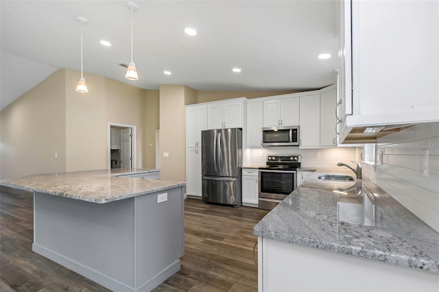 kitchen featuring white cabinets, lofted ceiling, sink, and appliances with stainless steel finishes