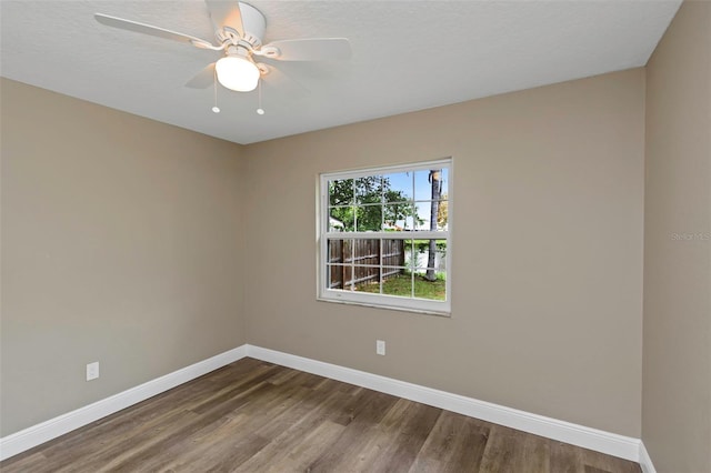 empty room with a textured ceiling, hardwood / wood-style flooring, and ceiling fan