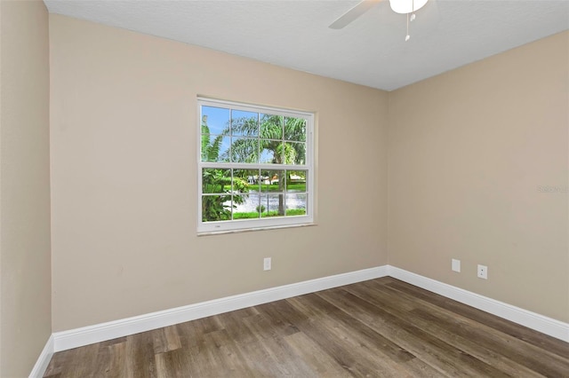 spare room with hardwood / wood-style floors and ceiling fan