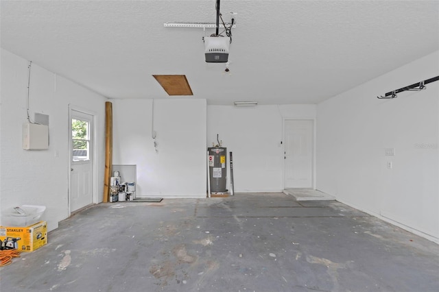 garage featuring water heater and a garage door opener