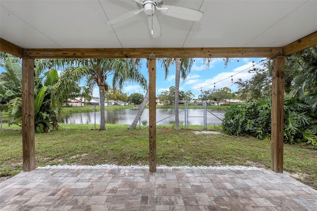 view of patio featuring a water view and ceiling fan