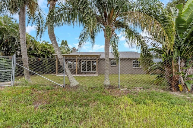 rear view of property featuring a yard