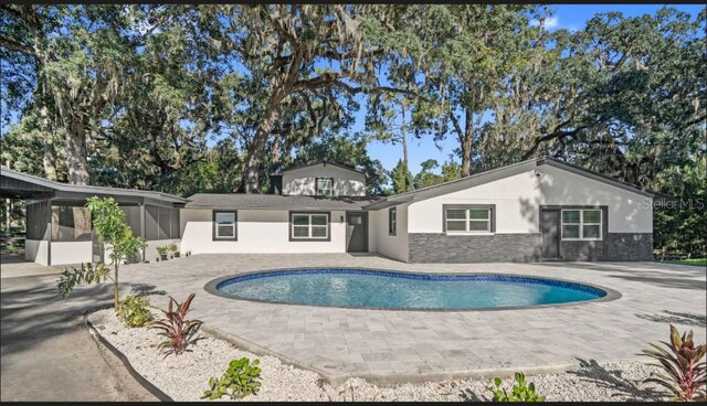 view of swimming pool with a patio area