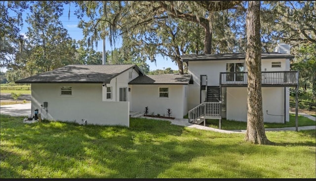 rear view of property featuring a yard