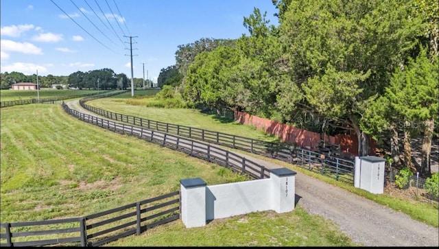 view of community featuring a yard and a rural view