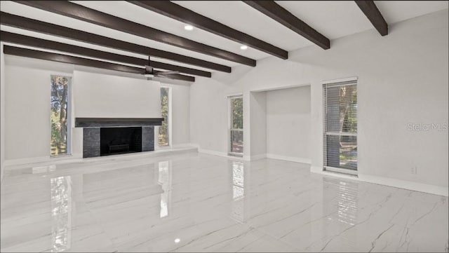 unfurnished living room featuring beamed ceiling and ceiling fan