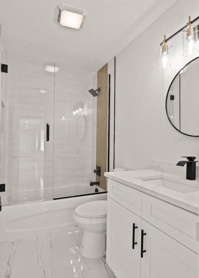 full bathroom featuring combined bath / shower with glass door, vanity, and toilet