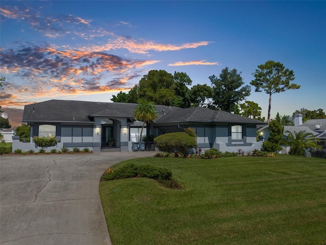 ranch-style home featuring a lawn