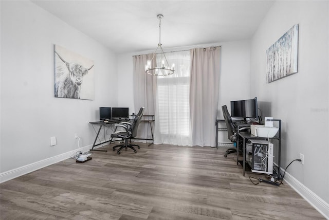 office area with a chandelier and hardwood / wood-style flooring