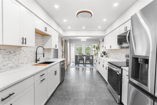 kitchen with sink, stainless steel appliances, and white cabinets