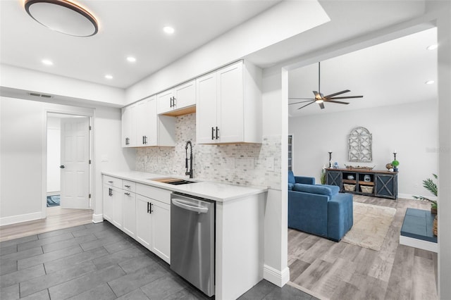 kitchen featuring ceiling fan, sink, white cabinetry, and stainless steel dishwasher