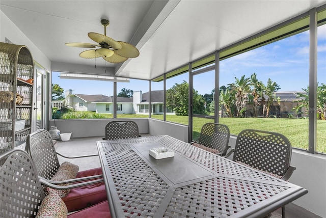 sunroom featuring ceiling fan