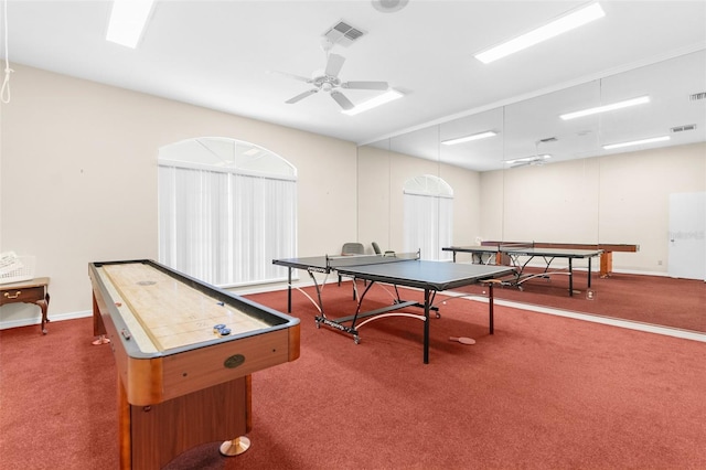 game room with ceiling fan and dark colored carpet