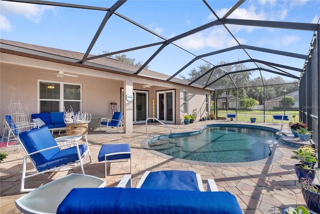 view of swimming pool featuring ceiling fan, glass enclosure, and a patio area