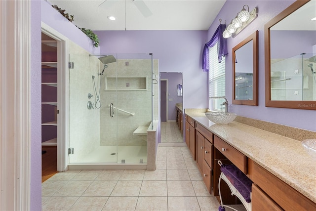 bathroom with vanity, ceiling fan, a shower with shower door, and tile patterned flooring