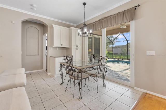 dining area featuring light tile patterned flooring, baseboards, and crown molding