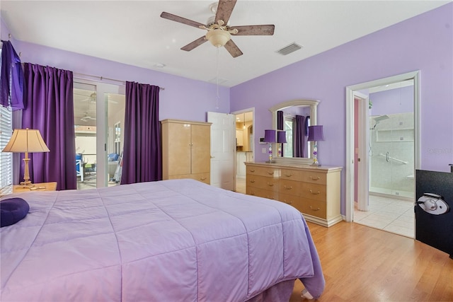 bedroom with light wood-style flooring, visible vents, connected bathroom, and a ceiling fan