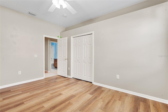 unfurnished bedroom with a closet, light hardwood / wood-style floors, and ceiling fan