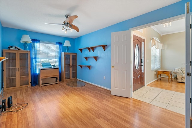 interior space with ceiling fan, french doors, wood finished floors, and ornamental molding
