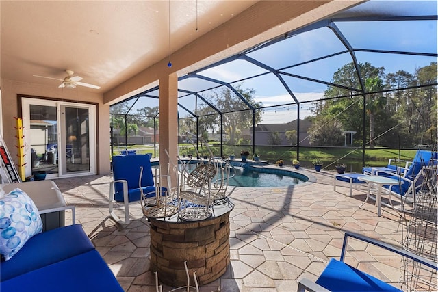 view of patio featuring an outdoor pool, a lanai, and a ceiling fan