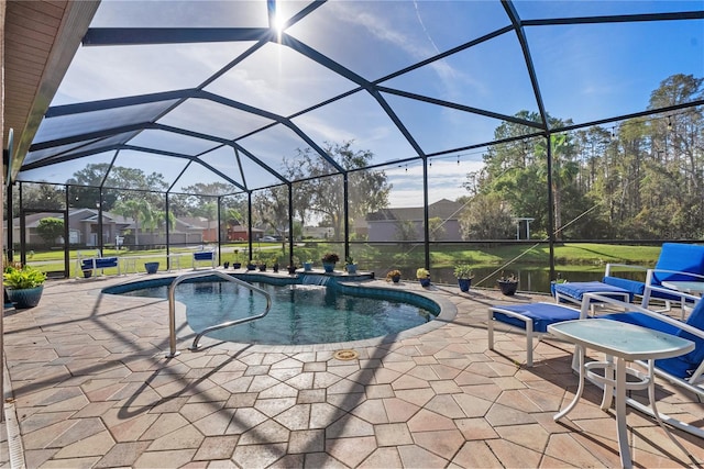 view of pool with a patio, a lanai, and a lawn