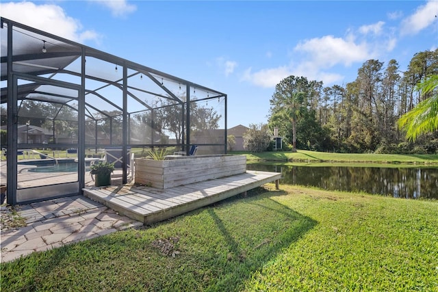 view of yard featuring a patio, a water view, and a lanai