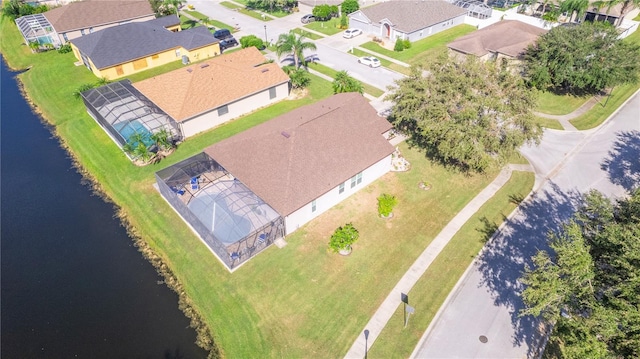 drone / aerial view with a water view and a residential view