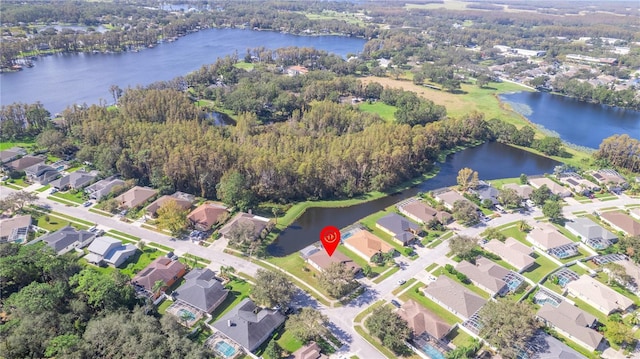 drone / aerial view featuring a water view and a residential view