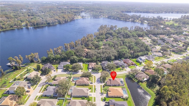 aerial view with a forest view, a residential view, and a water view