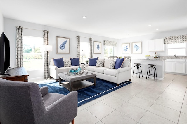 tiled living room featuring sink and a wealth of natural light