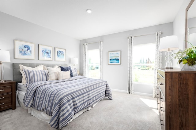 carpeted bedroom featuring multiple windows