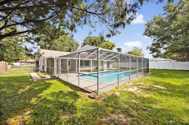 view of swimming pool with glass enclosure, a lawn, and a patio