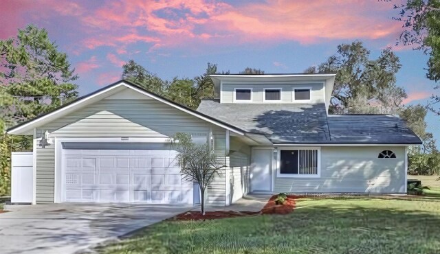 10221 Elgin Blvd, Spring Hill, FL 34608 - view of front of house with a yard, driveway, and a garage