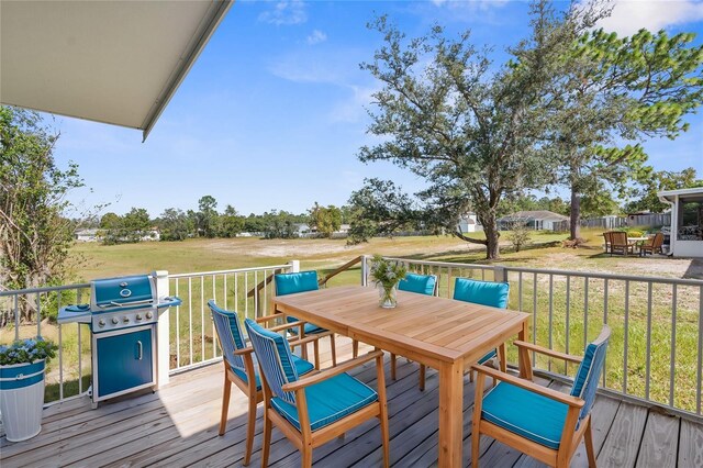 10221 Elgin Blvd, Spring Hill, FL 34608 - wooden terrace with area for grilling, outdoor dining area, and a yard