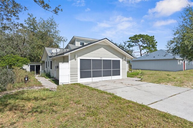 10221 Elgin Blvd, Spring Hill, FL 34608 - view of front facade featuring concrete driveway, a garage, and a front lawn