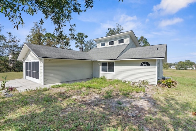 10221 Elgin Blvd, Spring Hill, FL 34608 - rear view of property featuring a garage and a lawn
