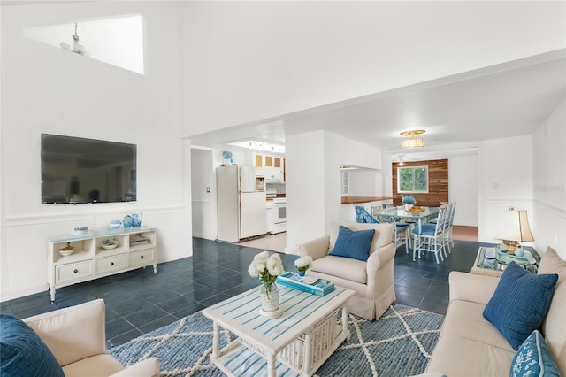 10221 Elgin Blvd, Spring Hill, FL 34608 - living area with dark tile patterned floors and a wainscoted wall