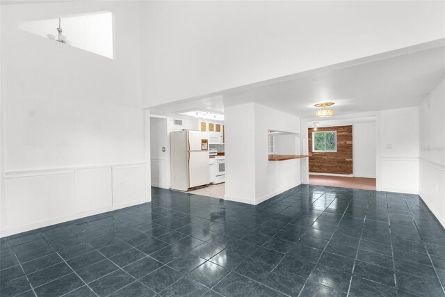 10221 Elgin Blvd, Spring Hill, FL 34608 - unfurnished living room featuring wainscoting and tile patterned flooring