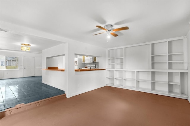10221 Elgin Blvd, Spring Hill, FL 34608 - unfurnished living room featuring ceiling fan and baseboards