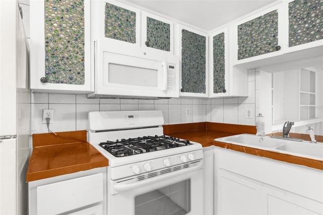 10221 Elgin Blvd, Spring Hill, FL 34608 - kitchen featuring white appliances, white cabinetry, glass insert cabinets, and decorative backsplash