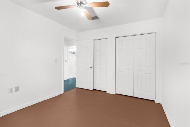 10221 Elgin Blvd, Spring Hill, FL 34608 - unfurnished bedroom with multiple closets and ceiling fan
