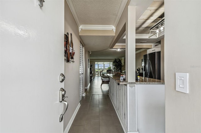 1847 Shore Dr S Unit 614, South Pasadena, FL 33707 - corridor with baseboards, ornamental molding, a textured ceiling, and dark tile patterned flooring