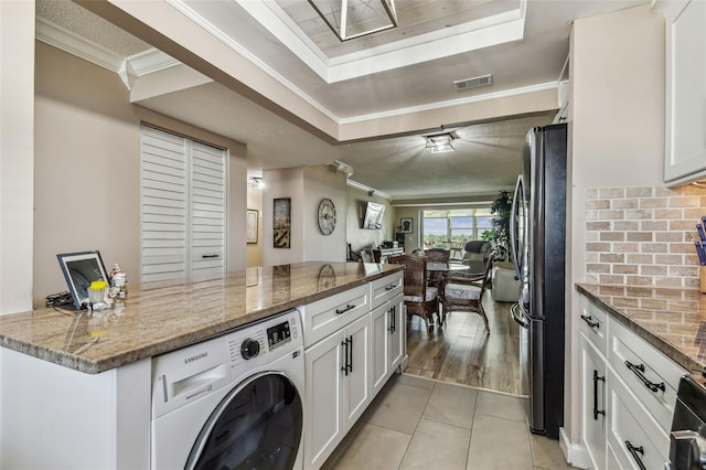 1847 Shore Dr S Unit 614, South Pasadena, FL 33707 - washroom with washer / dryer, light tile patterned flooring, visible vents, and ornamental molding