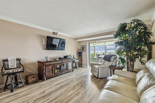 1847 Shore Dr S Unit 614, South Pasadena, FL 33707 - living area with visible vents, wood finished floors, a textured ceiling, and ornamental molding