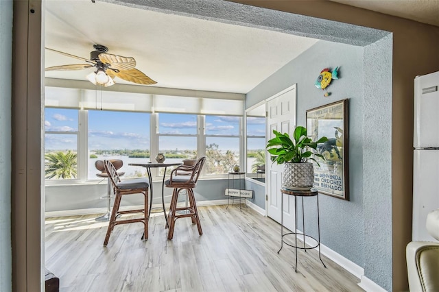 1847 Shore Dr S Unit 614, South Pasadena, FL 33707 - sunroom featuring a textured wall, wood finished floors, and baseboards