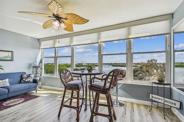 1847 Shore Dr S Unit 614, South Pasadena, FL 33707 - sunroom featuring wood finished floors, baseboards, and a water view